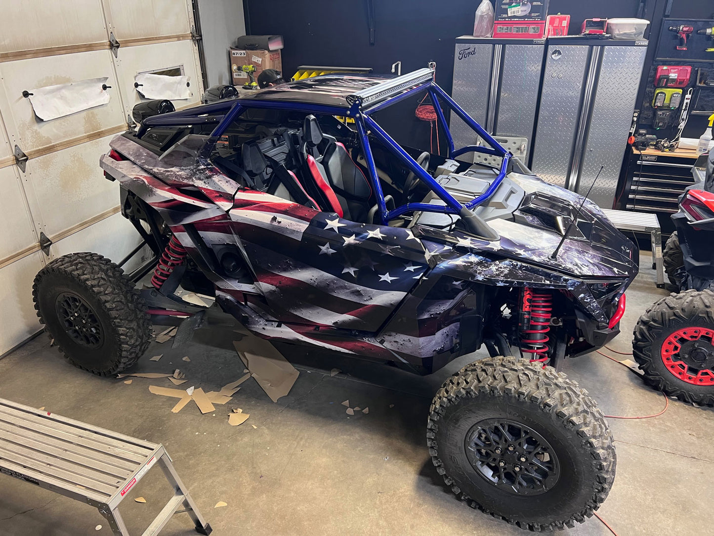 Full vehicle wrap on Polaris Pro R 2 seater featuring distressed flag theme